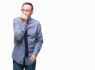 Middle age hoary senior business man wearing glasses over isolated background looking stressed and nervous with hands on mouth biting nails. Anxiety problem.