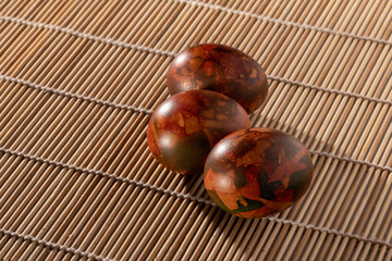 Easter eggs on a wooden tablecloth.