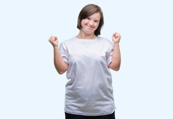 Fototapeta na wymiar Young adult woman with down syndrome over isolated background celebrating surprised and amazed for success with arms raised and open eyes. Winner concept.