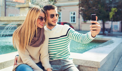 Happy couple making a selfie with mobile phone. Dating, love, relationships, lifestyle concept