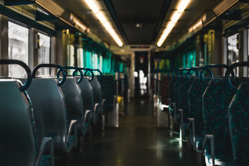 The interior of a suburban European train, view from the center with empty multidirectional rows of...
