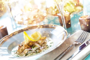 Close-up of Table with Food, Plates, Candles and Champagne