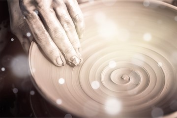 Hand of potter doing  clay pot on background