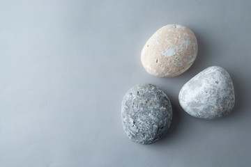 Grey stones isolated over grey background. Space for text