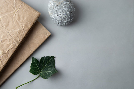 Flat lay of notebok with stone and green leave. Stil life. Business and education. Work table. minimalist style. Copy space.