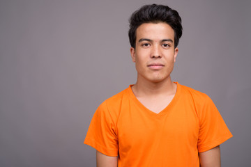 Obraz premium Portrait of young Asian man against gray background