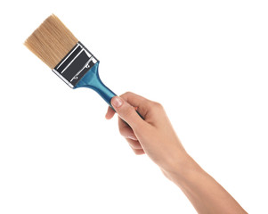Woman holding paint brush on white background, closeup