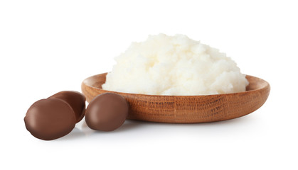 Shea butter in bowl and nuts isolated on white