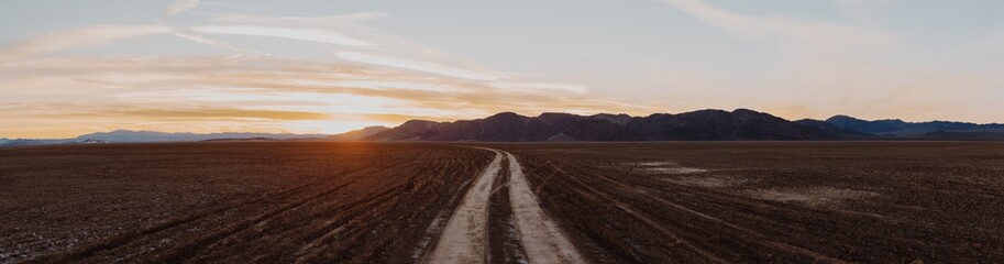 Fototapeta na wymiar Desert Road at Sunset