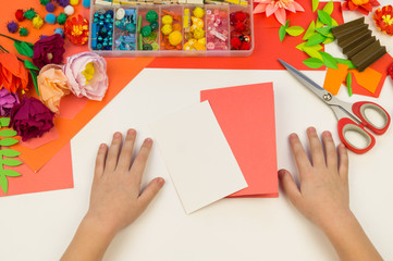 Child makes a postcard flat lay. Gift for mother a holiday on 8 March.