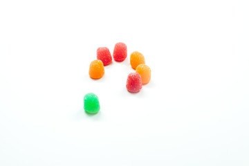 Inclusion - Open ring of gumdrops with one different colored gumdrop outside the circle