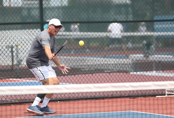 A gentleman competes in a pickleball tournament