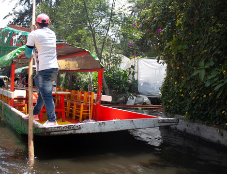 Boat driver in  Mexico City, opening the way to the main water attraction.