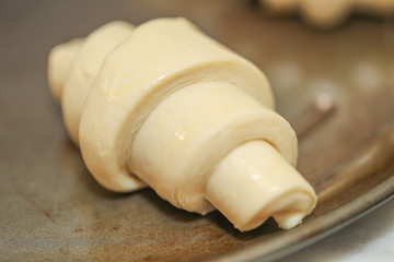 traditional St martin's croissants being prepared, croissants rolled lying on plate - Image