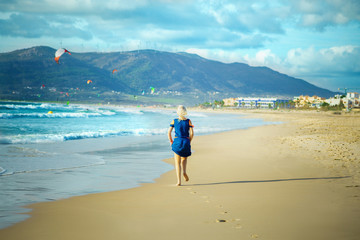 Woman runs on sandy beach