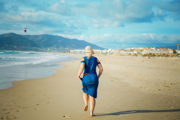 Woman runs on sandy beach