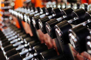 Fototapeta na wymiar Rows of dumbbells in the gym with hign contrast