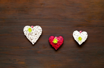 Chrysanthemums and decorative hearts on wooden background. Festive decor. 
