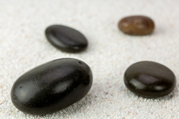 Fototapeta na wymiar Stones on a sea sand background