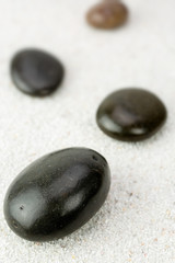 Fototapeta na wymiar Stones on a sea sand background