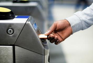 Man inserting a subway pass