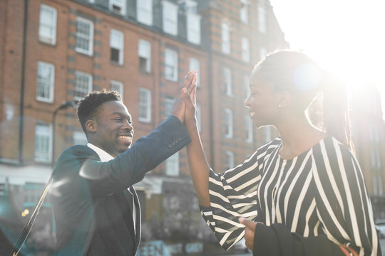 Colleagues giving each other a high five