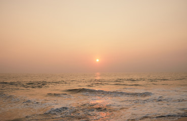 Fototapeta premium Stunning sunset on the beach overlooking the ocean and the waves. 