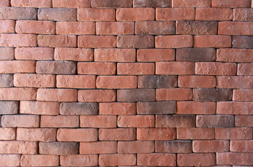 Red bricks arranged in rows near, Wall texture closeup