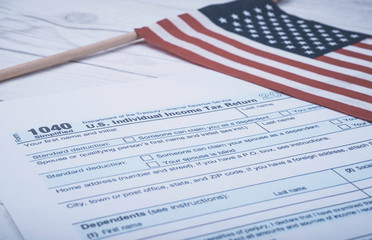 1040 Form US Individual Income Tax Refund next to American flag.
