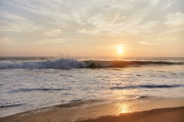 Narigama Beach. Stunning sunset on the beach overlooking the ocean and the waves.  