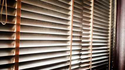 evening sun light outside with wooden window blinds, sunshine and shadow on window blind,...