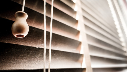 evening sun light outside with wooden window blinds, sunshine and shadow on window blind, decorative interior home concept 