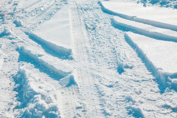 winter background with car traces on the snow