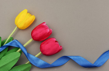 banner with red yellow tulips flowers on a grey background