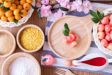 Kitchen table with Delectable imitation fruits, Fruit Shaped Mung Beans, Thai traditional dessert.