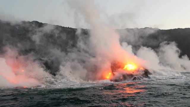 Lava ocean - flowing lava reaching ocean on Big Island, Hawaii. Lava stream seen from the water flowing from Kilauea volcano near Hawaii volcanoes national park, USA. 59.94 FPS, Steadicam.