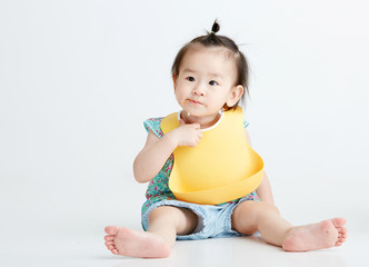 Asian little girl eating, in white background