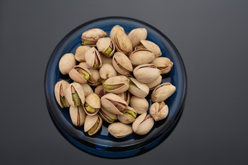 Roasted pistachio seeds with shell in bowl