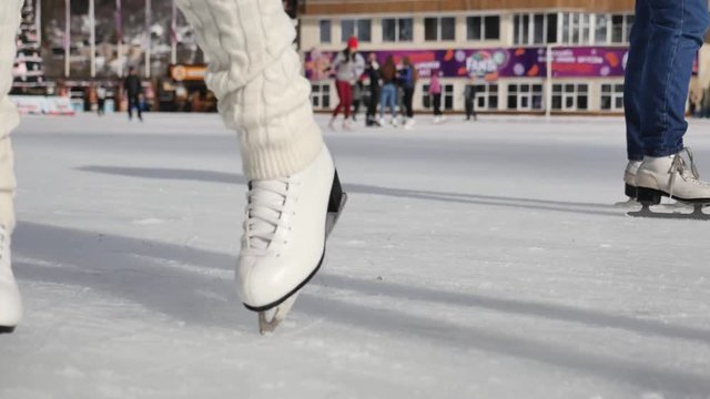 women learn ice skating outdoor at ice rink