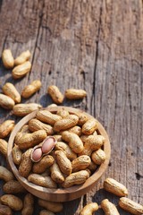 Peanut, snack, in wood bowl on classic wooden table background