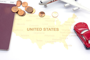 passport compass and coins on a American map. business travel concept