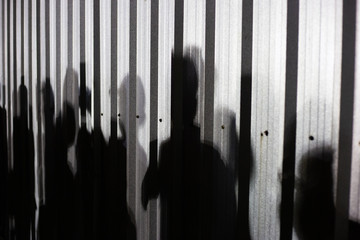People shadow on zinc wall.