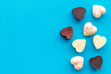 Heart-shaped confection for Valentine's day on blue background top view space for text