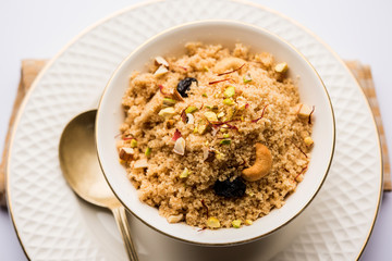 Semolina Halwa / Sooji ka Halva or sweet Rava Sheera or shira - Indian festival sweet made of semolina, nuts and Ghee