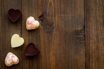 Heart-shaped confection for Valentine's day on dark wooden background top view space for text