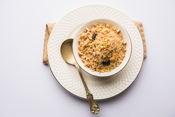 Semolina Halwa / Sooji ka Halva or sweet Rava Sheera or shira - Indian festival sweet made of semolina, nuts and Ghee