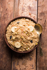 Semolina Halwa / Sooji ka Halva or sweet Rava Sheera or shira - Indian festival sweet made of semolina, nuts and Ghee