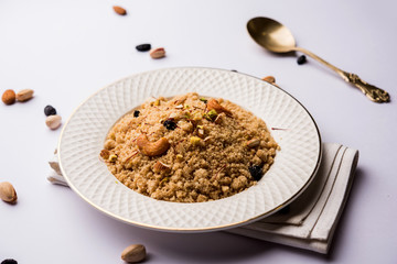 Semolina Halwa / Sooji ka Halva or sweet Rava Sheera or shira - Indian festival sweet made of semolina, nuts and Ghee