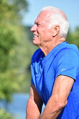 Athletic Male Senior Stretching By River