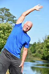 Naklejka premium Athletic Male Senior Stretching By River